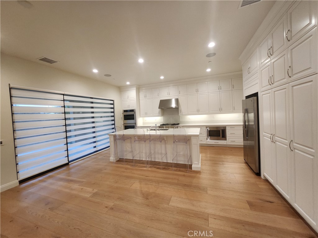 20717 Pine Cone Circle Porter Ranch, CA 91326 - Photo 5 of 31 a kitchen with stainless steel appliances granite countertop a refrigerator and a stove
