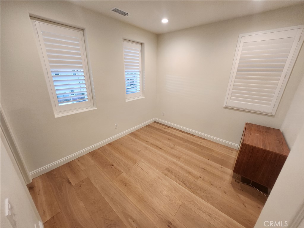 20717 Pine Cone Circle Porter Ranch, CA 91326 - Photo 10 of 31 a view of room with window and wooden floor