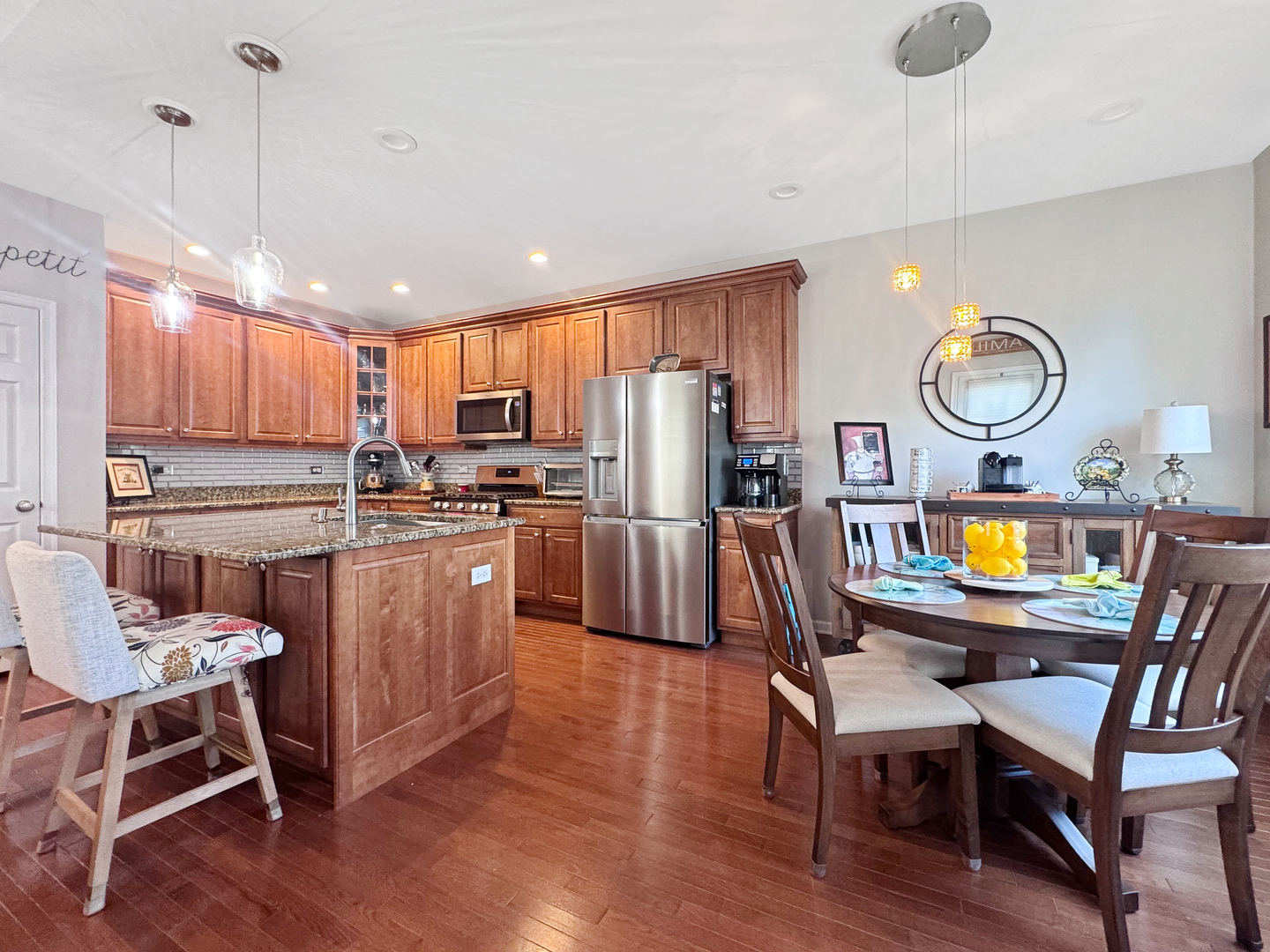 1210 Falcon Ridge Drive Elgin, IL 60124 - Photo 16 of 35 a kitchen with stainless steel appliances granite countertop a stove a sink dishwasher a dining table and chairs with wooden floor