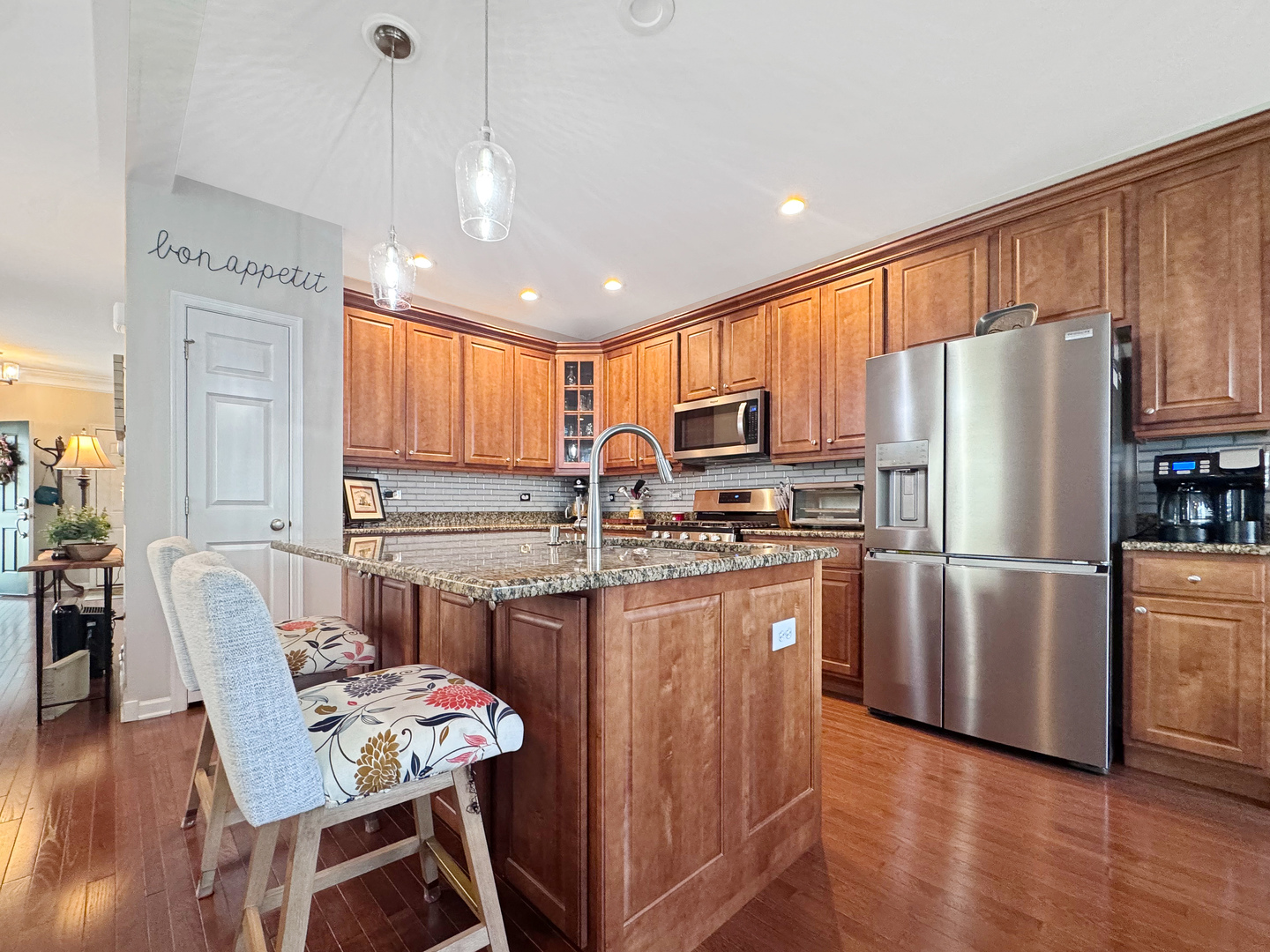1210 Falcon Ridge Drive Elgin, IL 60124 - Photo 17 of 35 a kitchen with refrigerator a stove a dining table and chairs