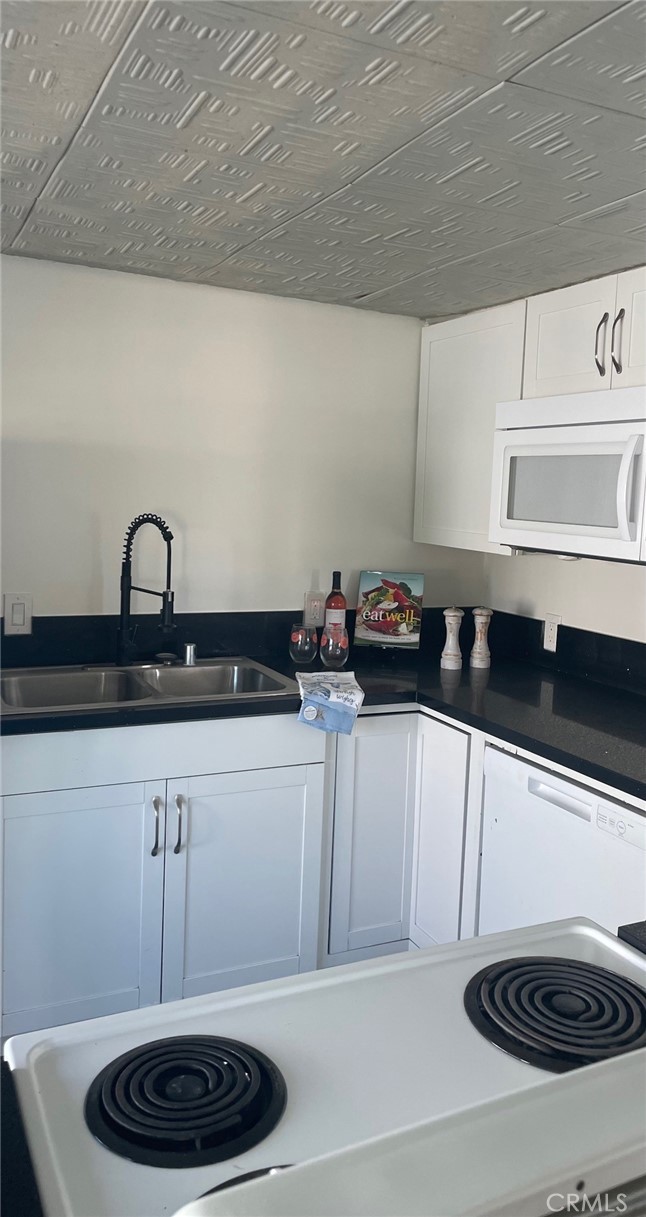 32802 Valle Road, Unit 135 San Juan Capistrano, CA 92675 - Photo 1 of 26 a kitchen with a sink a stove and cabinets