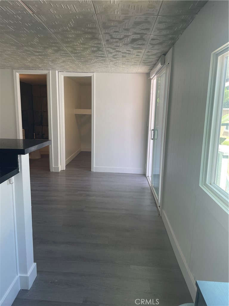 32802 Valle Road, Unit 135 San Juan Capistrano, CA 92675 - Photo 12 of 26 an empty room with wooden floor and windows