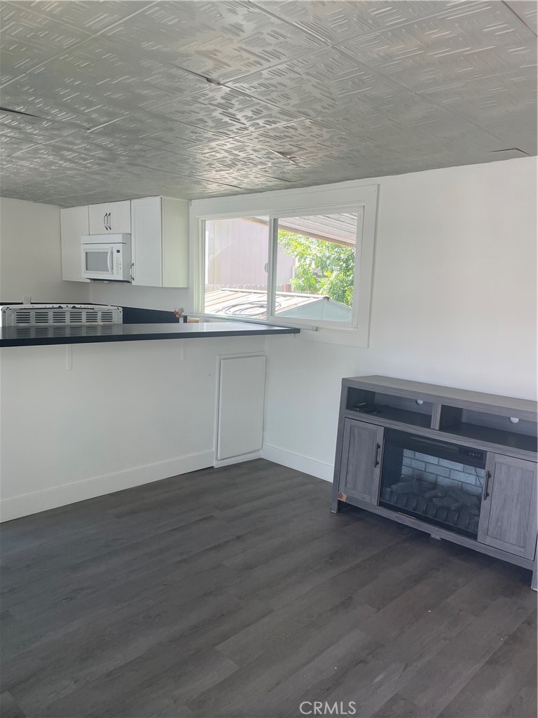 32802 Valle Road, Unit 135 San Juan Capistrano, CA 92675 - Photo 13 of 26 a view of a kitchen with wooden floor and a sink