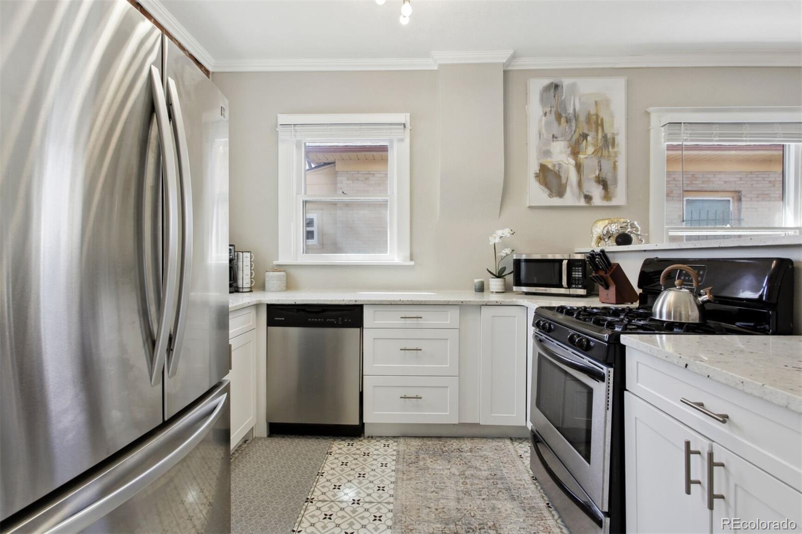 4138 Shoshone Street Denver, CO 80211 - Photo 11 of 27 a kitchen with stainless steel appliances granite countertop a stove a sink and a refrigerator