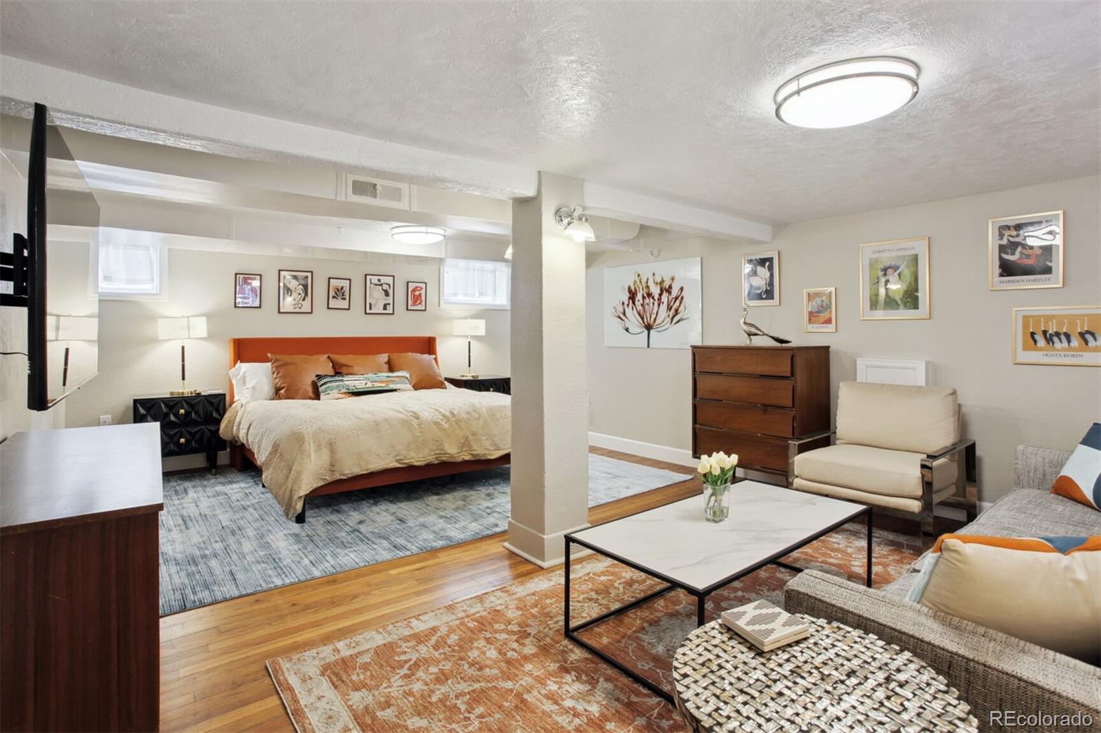 4138 Shoshone Street Denver, CO 80211 - Photo 14 of 27 a bedroom with a bed a table and chair