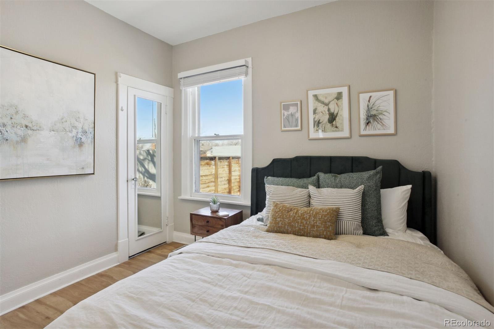 4138 Shoshone Street Denver, CO 80211 - Photo 15 of 27 a bedroom with a bed and painting on the wall