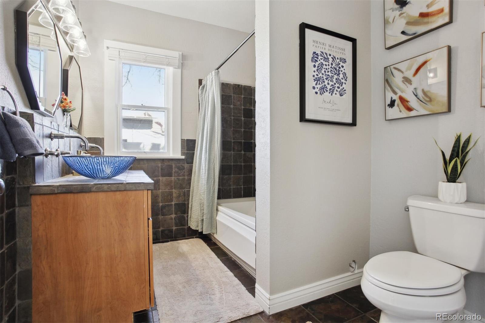 4138 Shoshone Street Denver, CO 80211 - Photo 19 of 27 a bathroom with a toilet and a shower