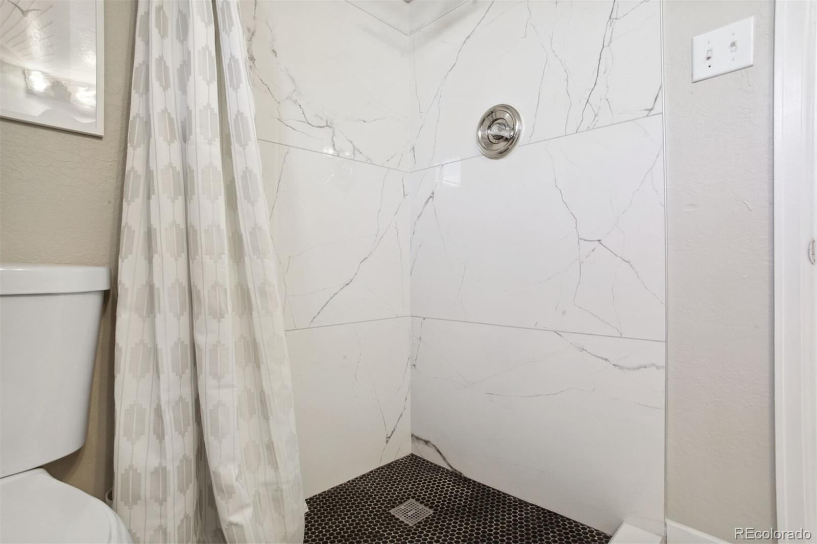 4138 Shoshone Street Denver, CO 80211 - Photo 23 of 27 a bathroom with a shower