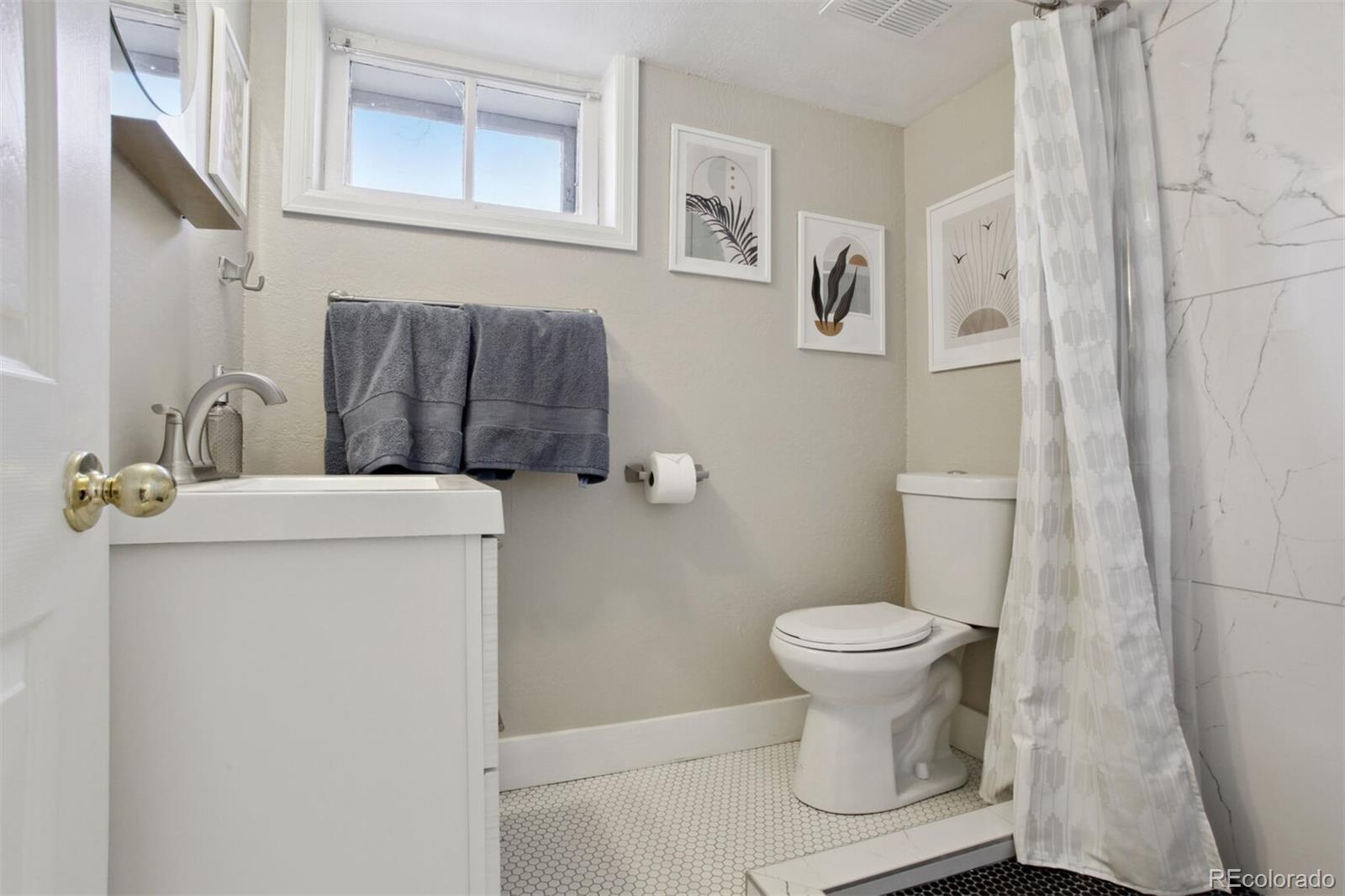 4138 Shoshone Street Denver, CO 80211 - Photo 24 of 27 a bathroom with a sink toilet and a mirror