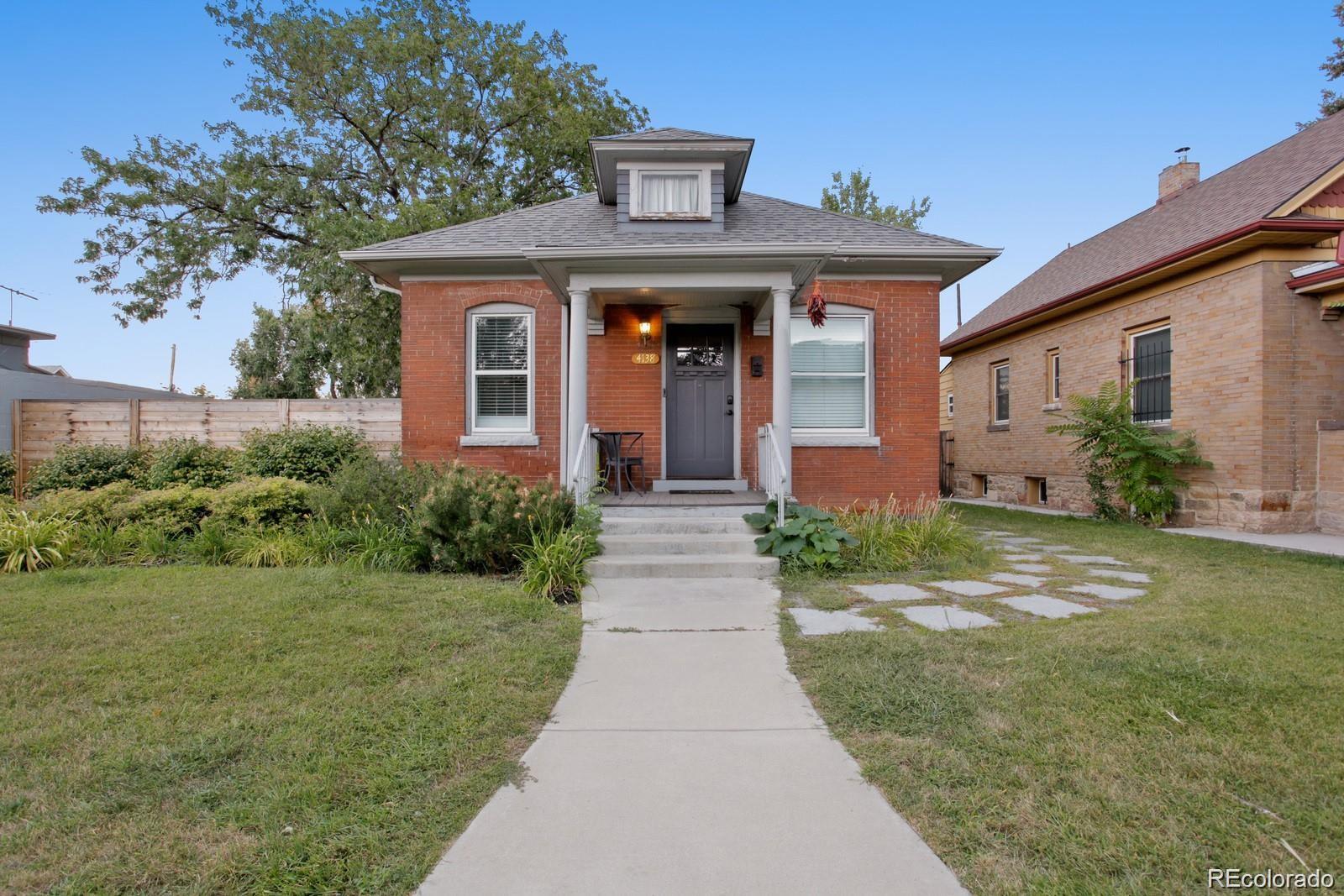 4138 Shoshone Street Denver, CO 80211 - Photo 26 of 27 a front view of a house with garden