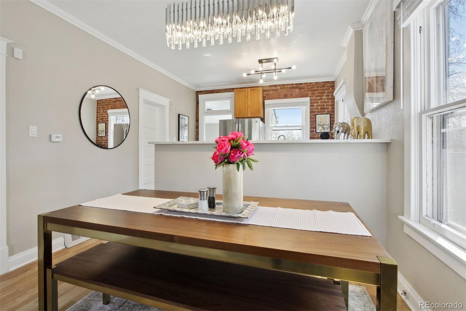 4138 Shoshone Street Denver, CO 80211 - Photo 6 of 27 a dining room with table chairs and chandelier