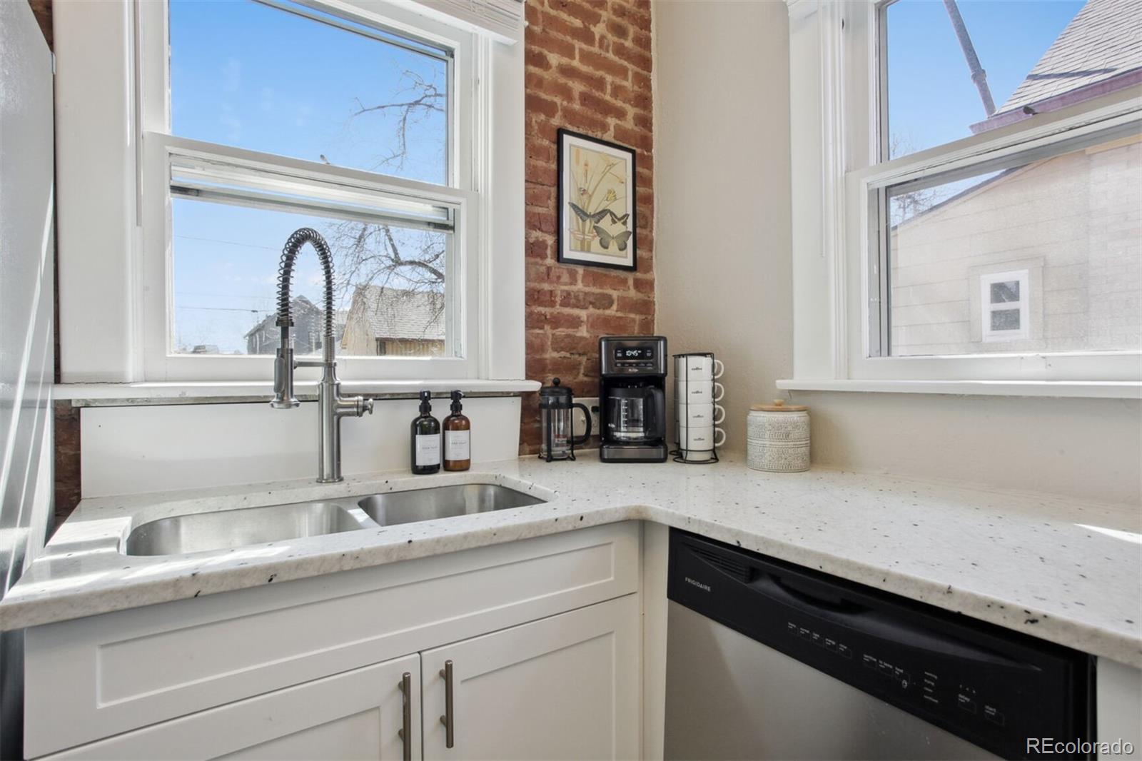 4138 Shoshone Street Denver, CO 80211 - Photo 8 of 27 a kitchen with a sink and cabinets