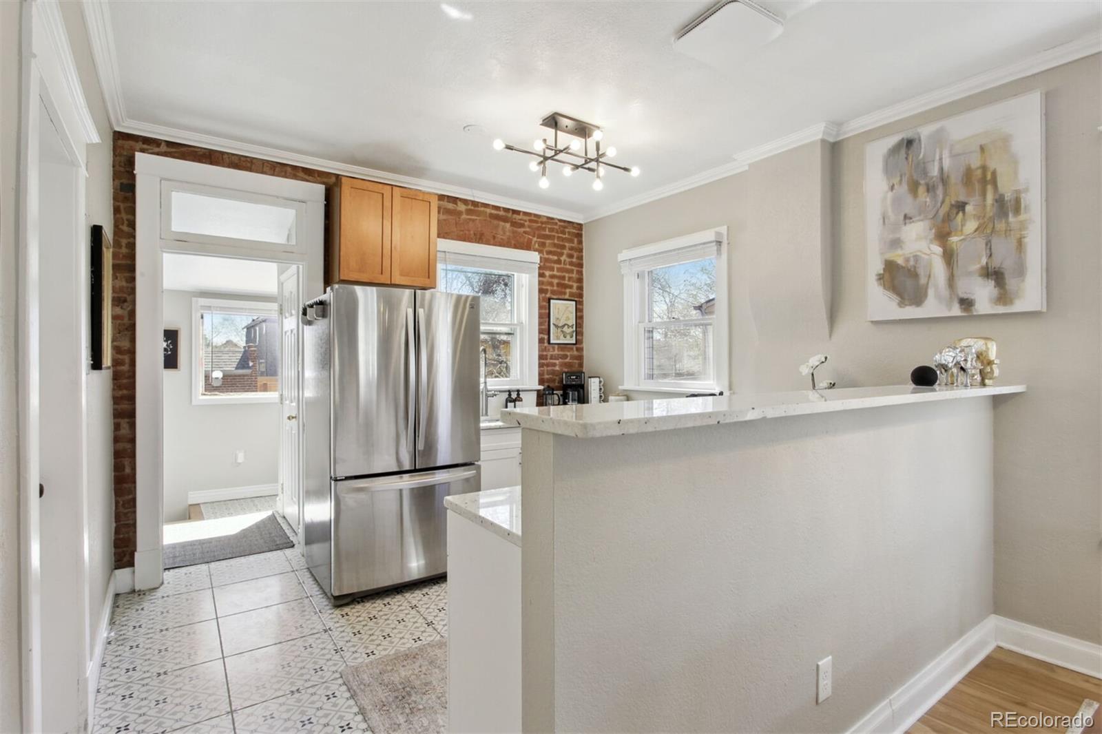 4138 Shoshone Street Denver, CO 80211 - Photo 10 of 27 a view of a refrigerator in kitchen and a window
