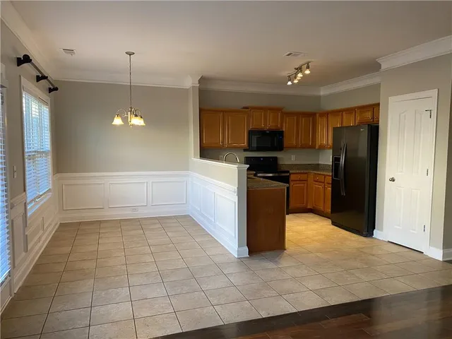 a kitchen with stainless steel appliances a refrigerator and a stove top oven