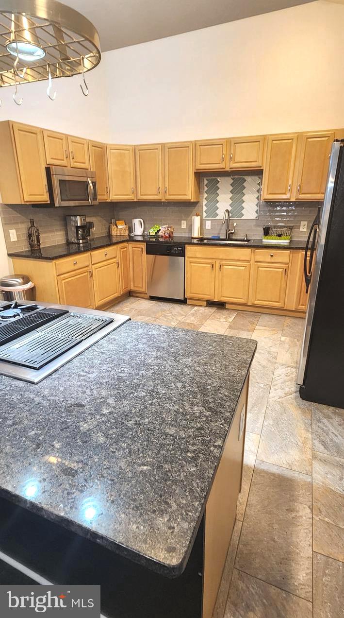 1112 Lee Road Basye, VA 22810 - Photo 24 of 102 a view of a kitchen with kitchen island a sink wooden floor and living room view
