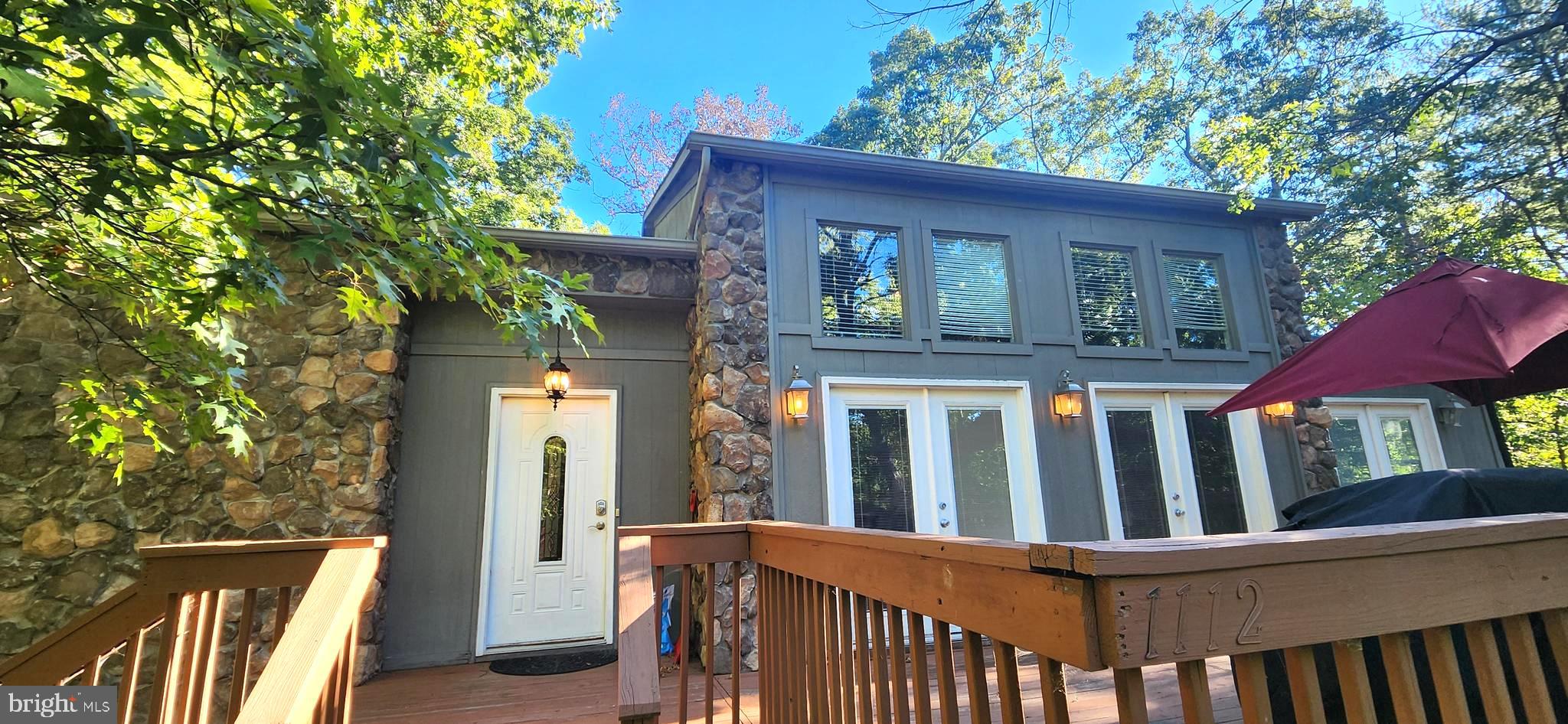 1112 Lee Road Basye, VA 22810 - Photo 3 of 102 a view of a brick house with a large window