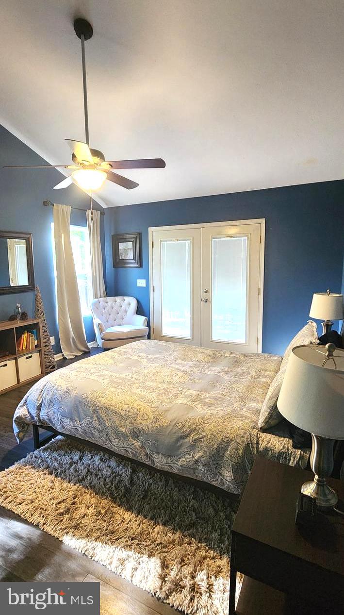 1112 Lee Road Basye, VA 22810 - Photo 31 of 102 a bedroom with a bed and a chandelier