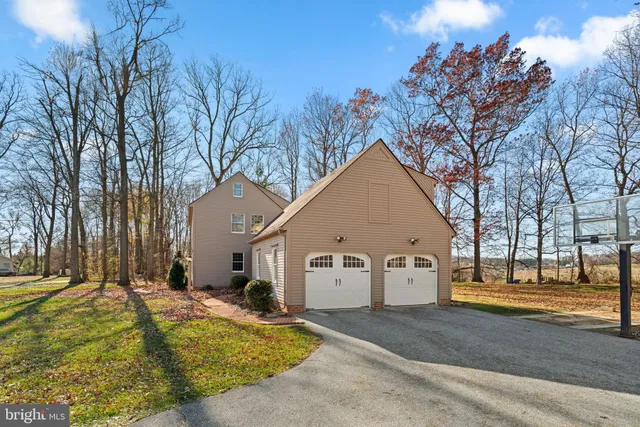 a view of a white house with a yard covered in snow
