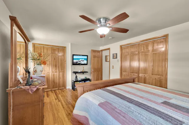 a spacious bedroom with a large bed and a chandelier