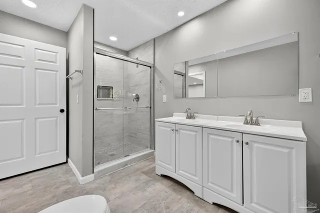 a bathroom with a double vanity sink and mirror