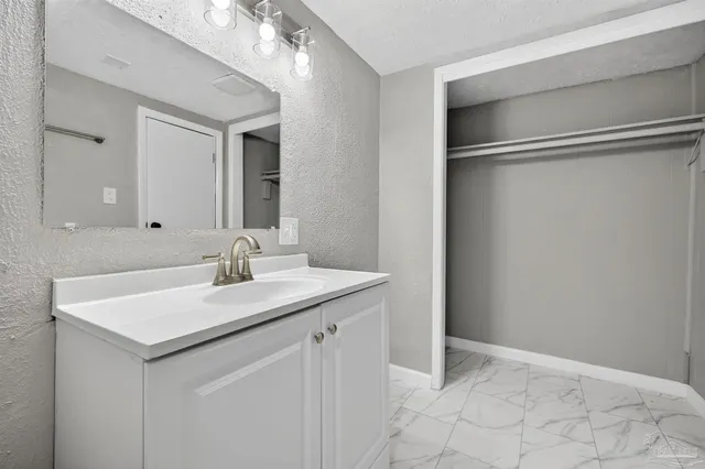 a bathroom with a sink vanity and mirror