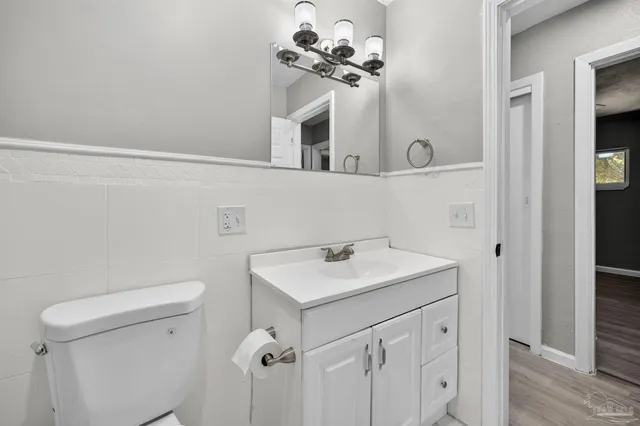 a bathroom with a sink vanity and a mirror