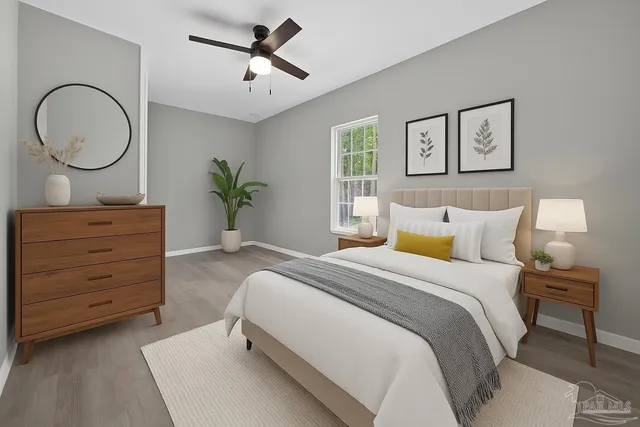 a spacious bedroom with a bed a mirror and a window