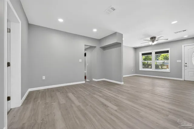 an empty room with windows and closet