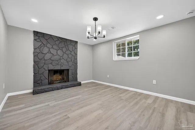 a view of an empty room with a fireplace