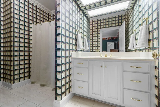a view of a patio with table and chairs and floor to ceiling window with garden view