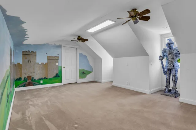 a bathroom with a granite countertop toilet sink and mirror