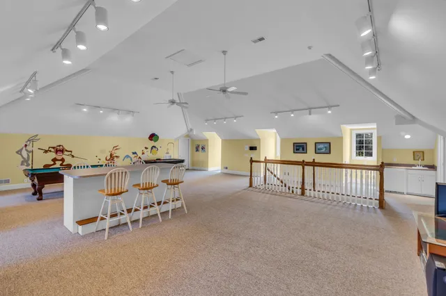 a view of a house with a swimming pool and sitting area