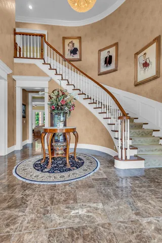 a view of a dining room with furniture a rug and wooden floor