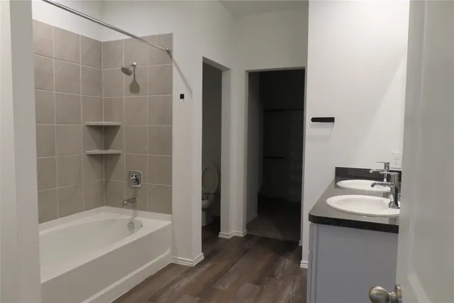 a bathroom with a bathtub a sink a vanity and a shower