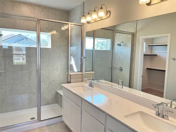 a bathroom with a double vanity sink and a mirror