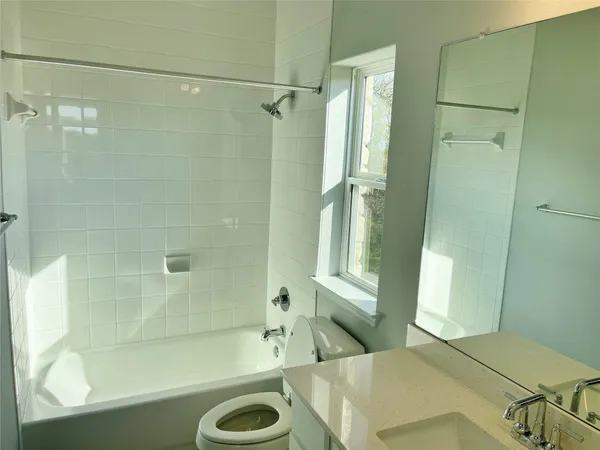 a bathroom with a tub a sink and a shower