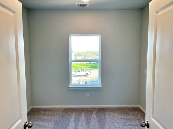 a view of an empty room and a window