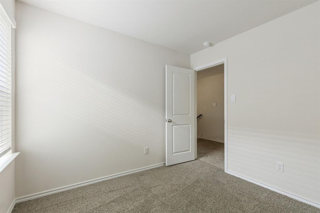 317 Clematis Street Princeton, TX 75407 - Photo 26 of 38 Empty room with carpet flooring and healthy amount of natural light