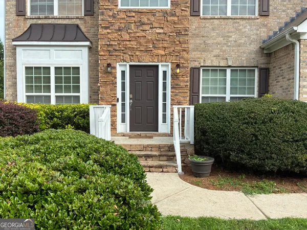 a front view of a house with garden