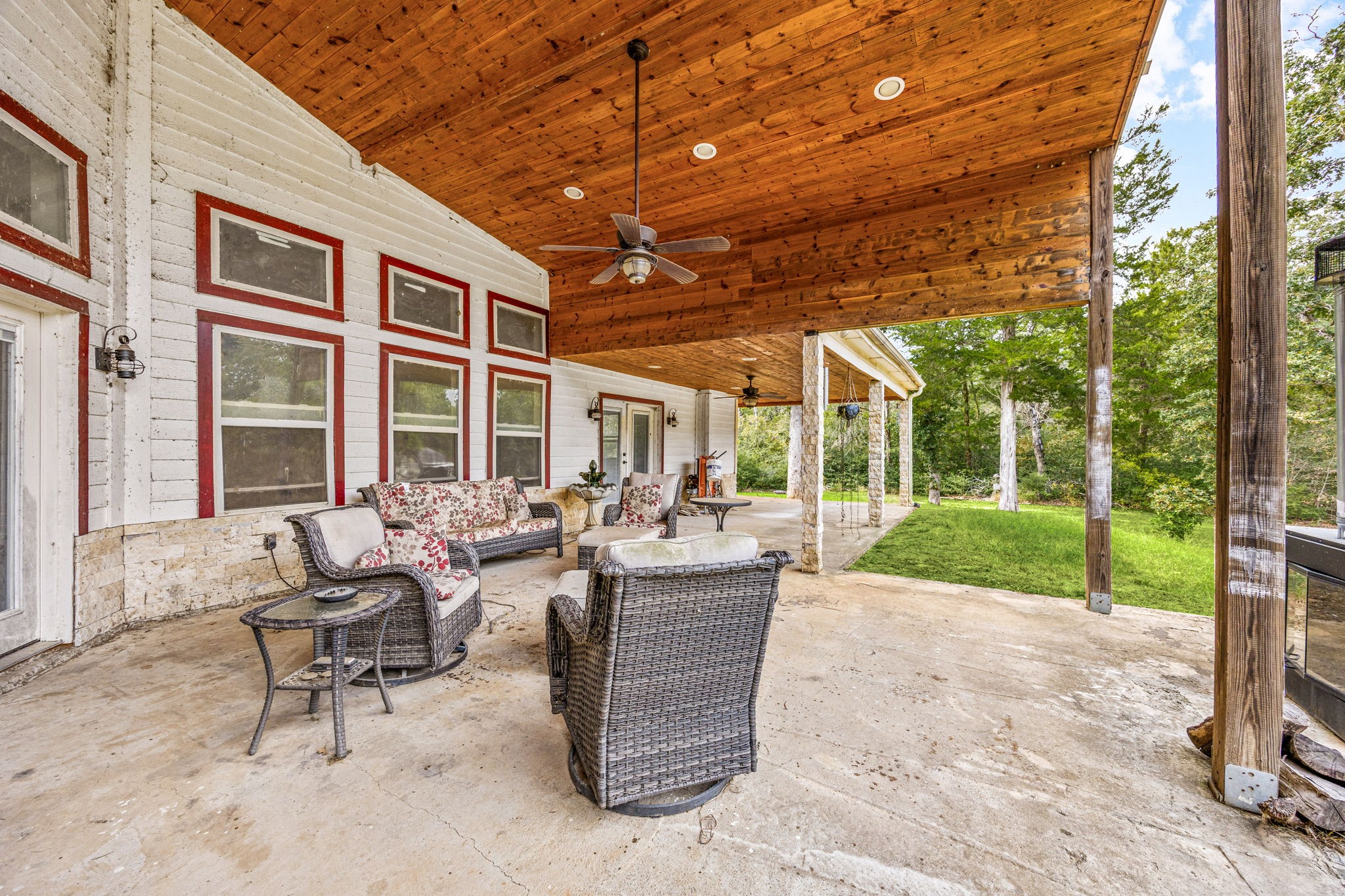 7336 Highland Ranch Road Caldwell, TX 77836 - Photo 18 of 25 a view of a patio with couches chairs and a big yard