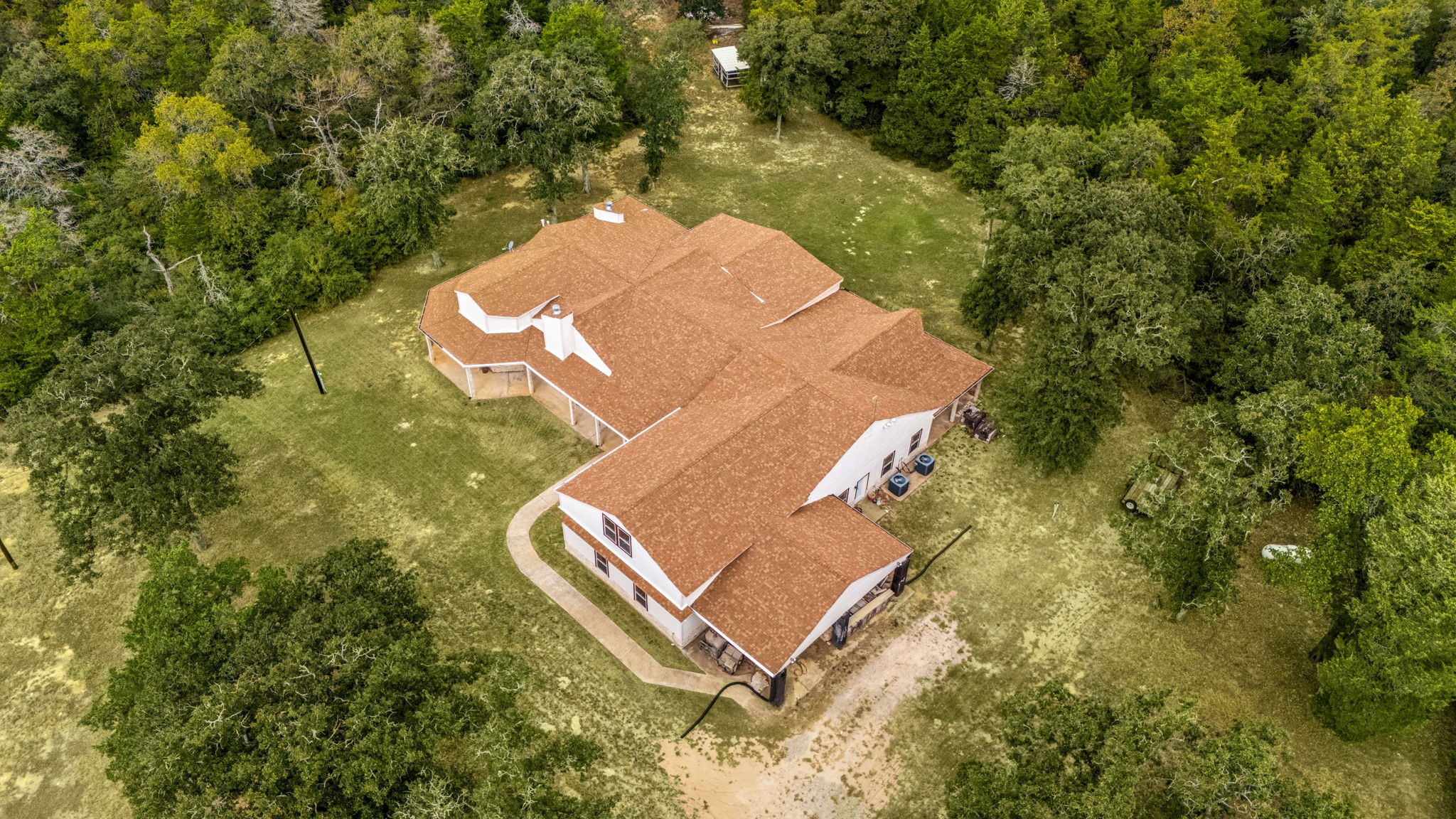 7336 Highland Ranch Road Caldwell, TX 77836 - Photo 20 of 25 an aerial view of a house with a yard and trees all around