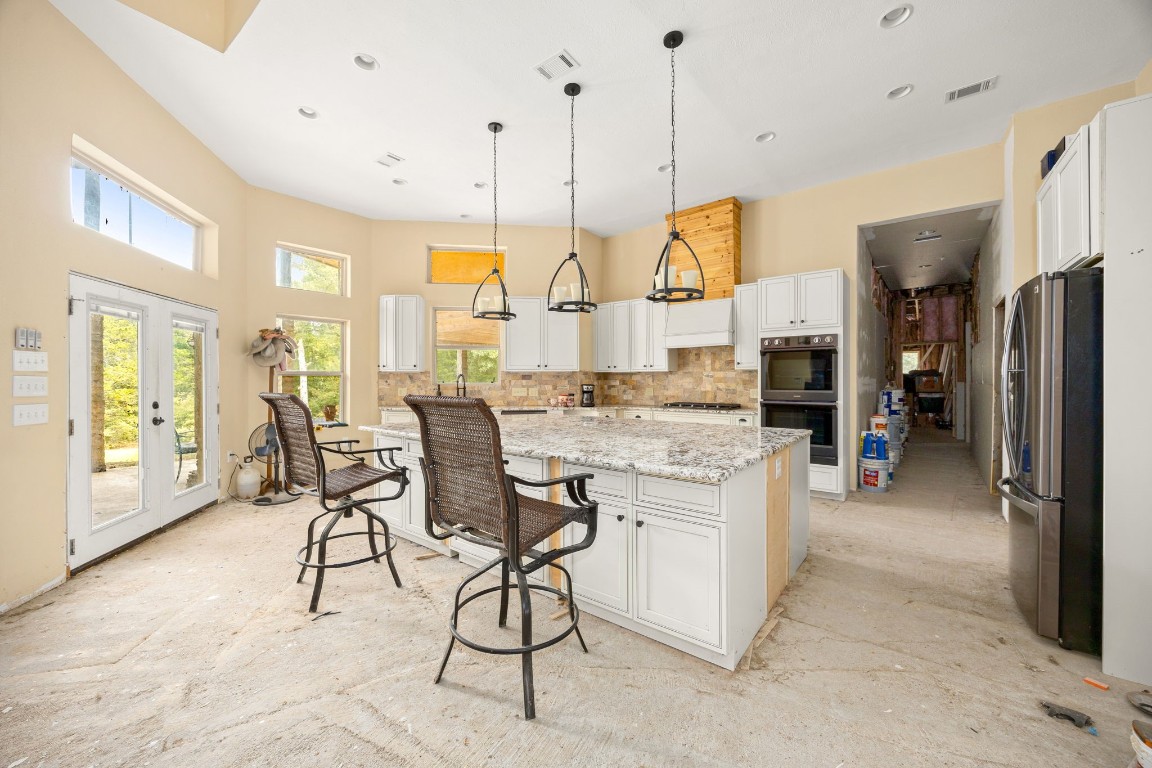 7336 Highland Ranch Road Caldwell, TX 77836 - Photo 5 of 25 a open kitchen with stainless steel appliances granite countertop a stove and cabinets