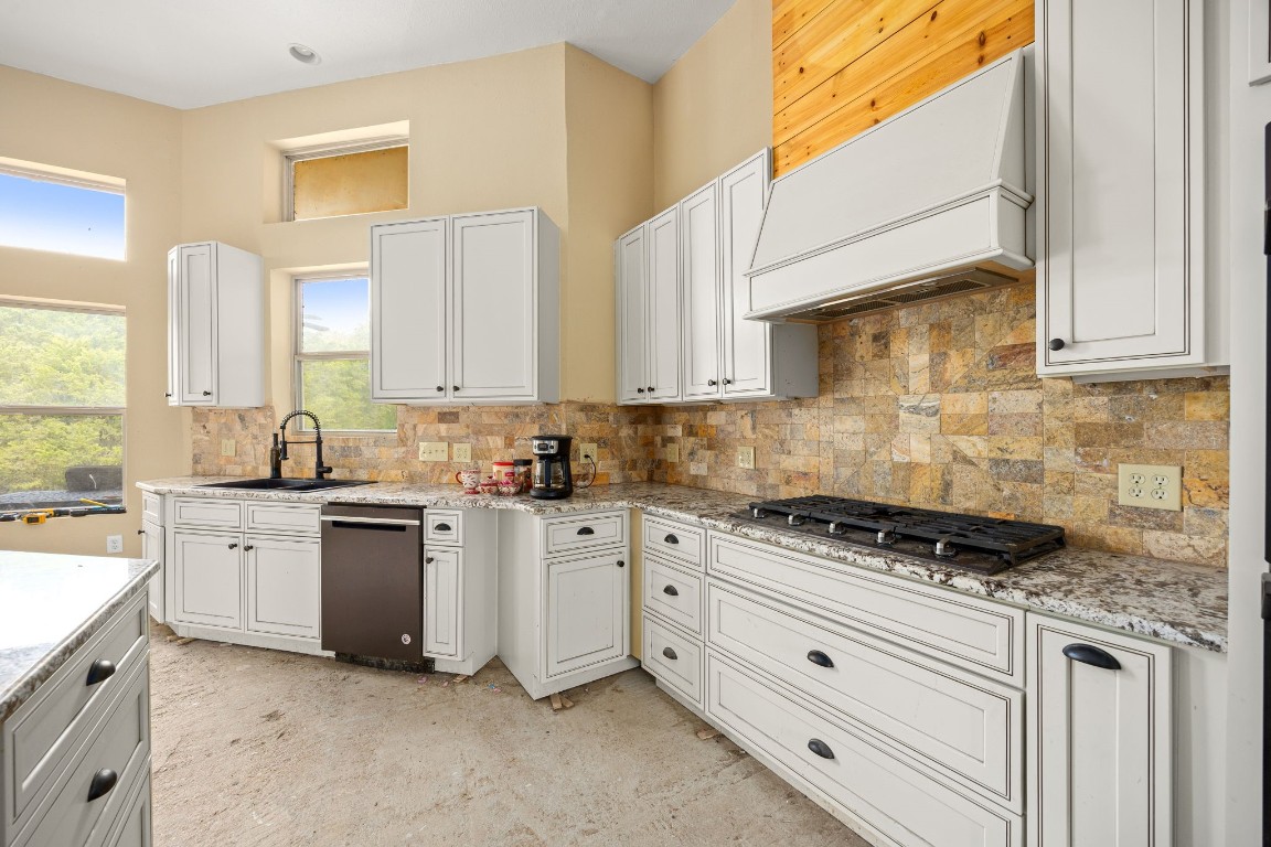 7336 Highland Ranch Road Caldwell, TX 77836 - Photo 9 of 25 a kitchen with stainless steel appliances granite countertop grey cabinets a stove a sink and a window