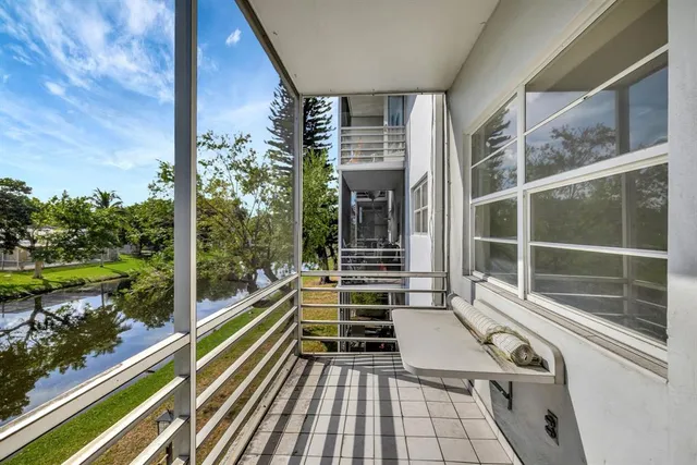 a view of a balcony with floor to ceiling windows with wooden floor