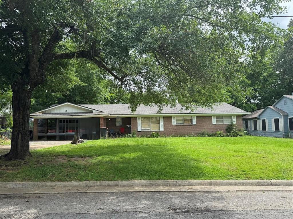 4515 Southeast Loop 286 Paris, TX 75460 - Photo 23 of 37 a front view of a house with a yard