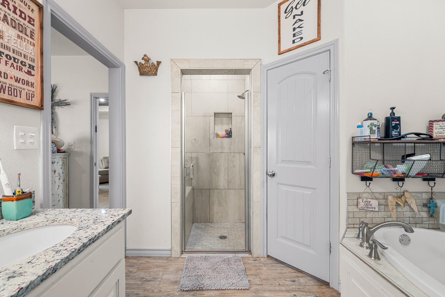 542 Nora Road Wilson, TX 79381 - Photo 13 of 42 a bathroom with a granite countertop tub sink and shower