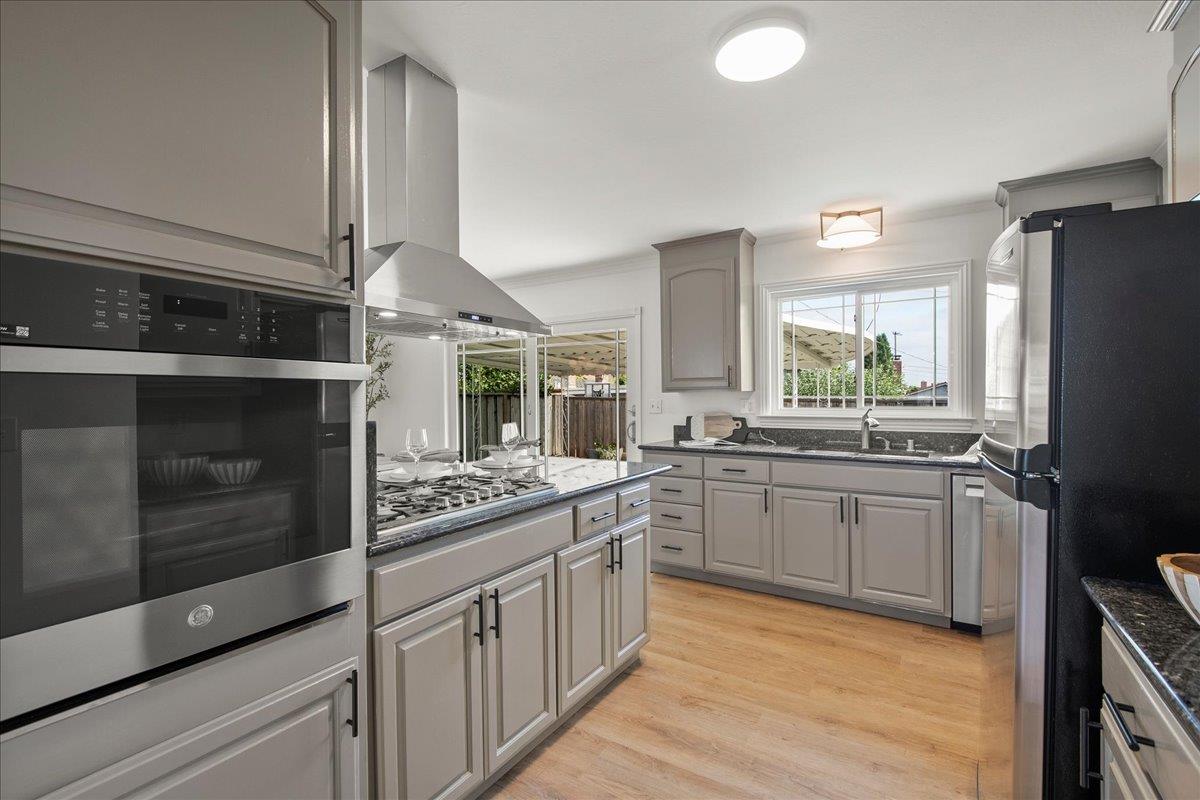 7669 Rainbow Drive Cupertino, CA 95014 - Photo 18 of 37 a kitchen with stainless steel appliances granite countertop a stove a sink and a refrigerator