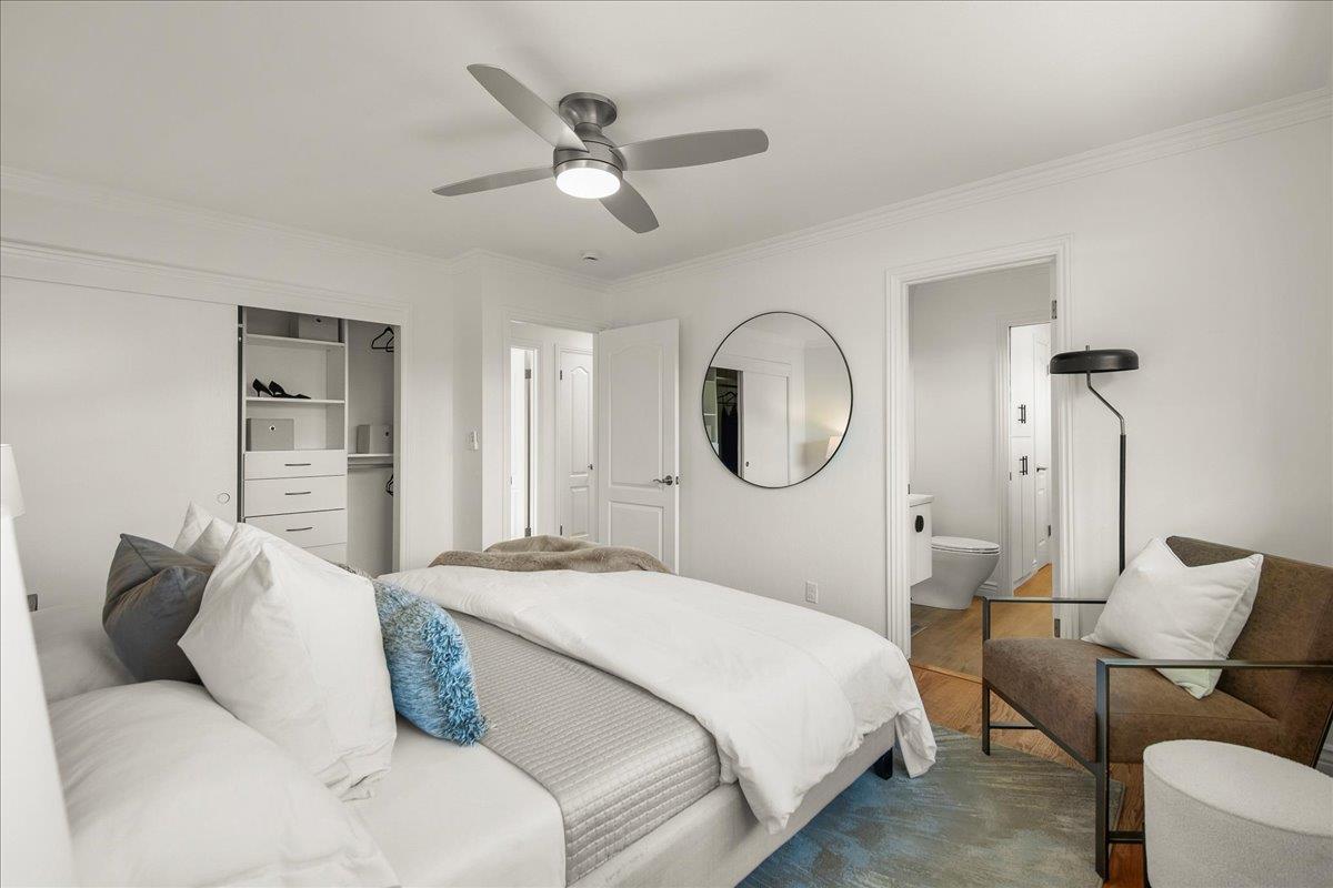 7669 Rainbow Drive Cupertino, CA 95014 - Photo 22 of 37 a bedroom with a large bed and a chandelier