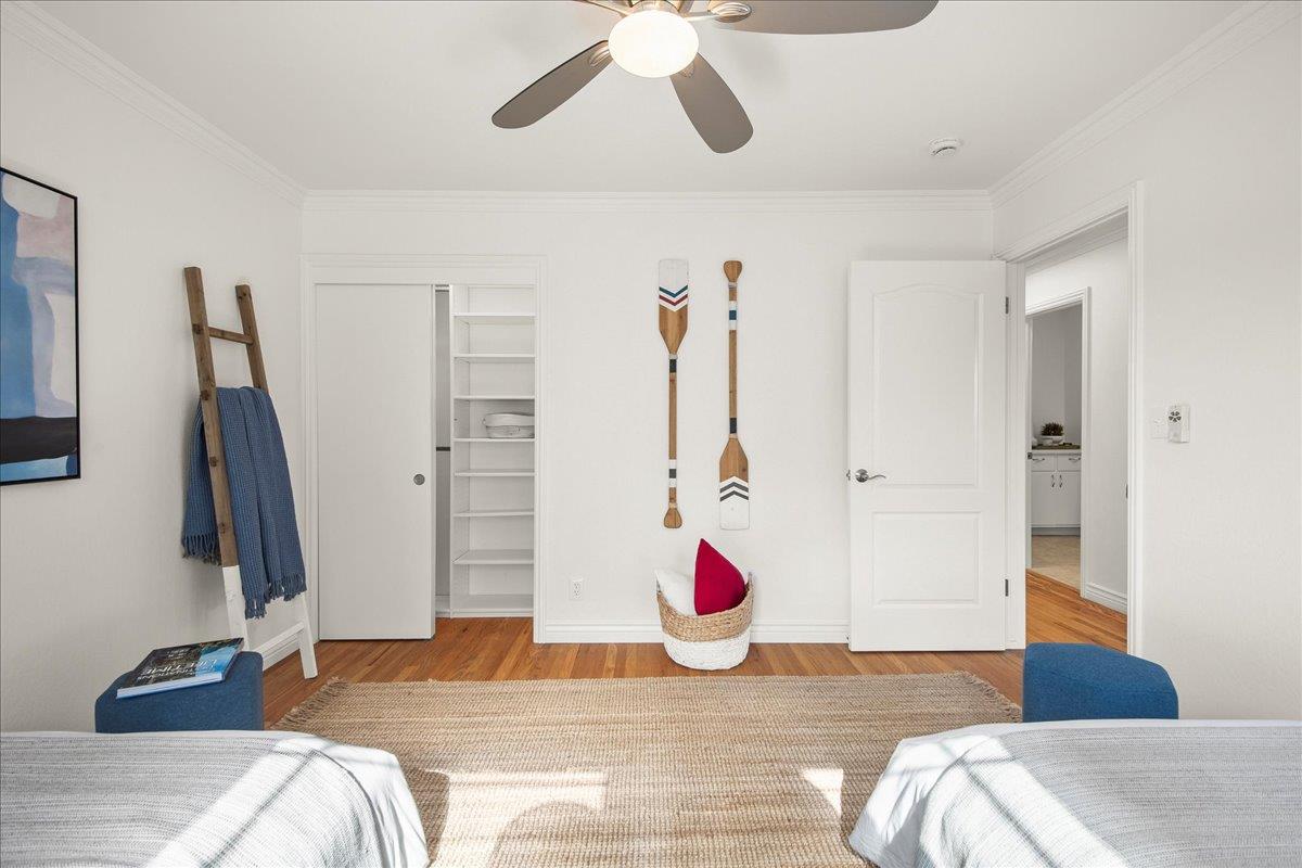 7669 Rainbow Drive Cupertino, CA 95014 - Photo 26 of 37 a bedroom with a bed and a chandelier