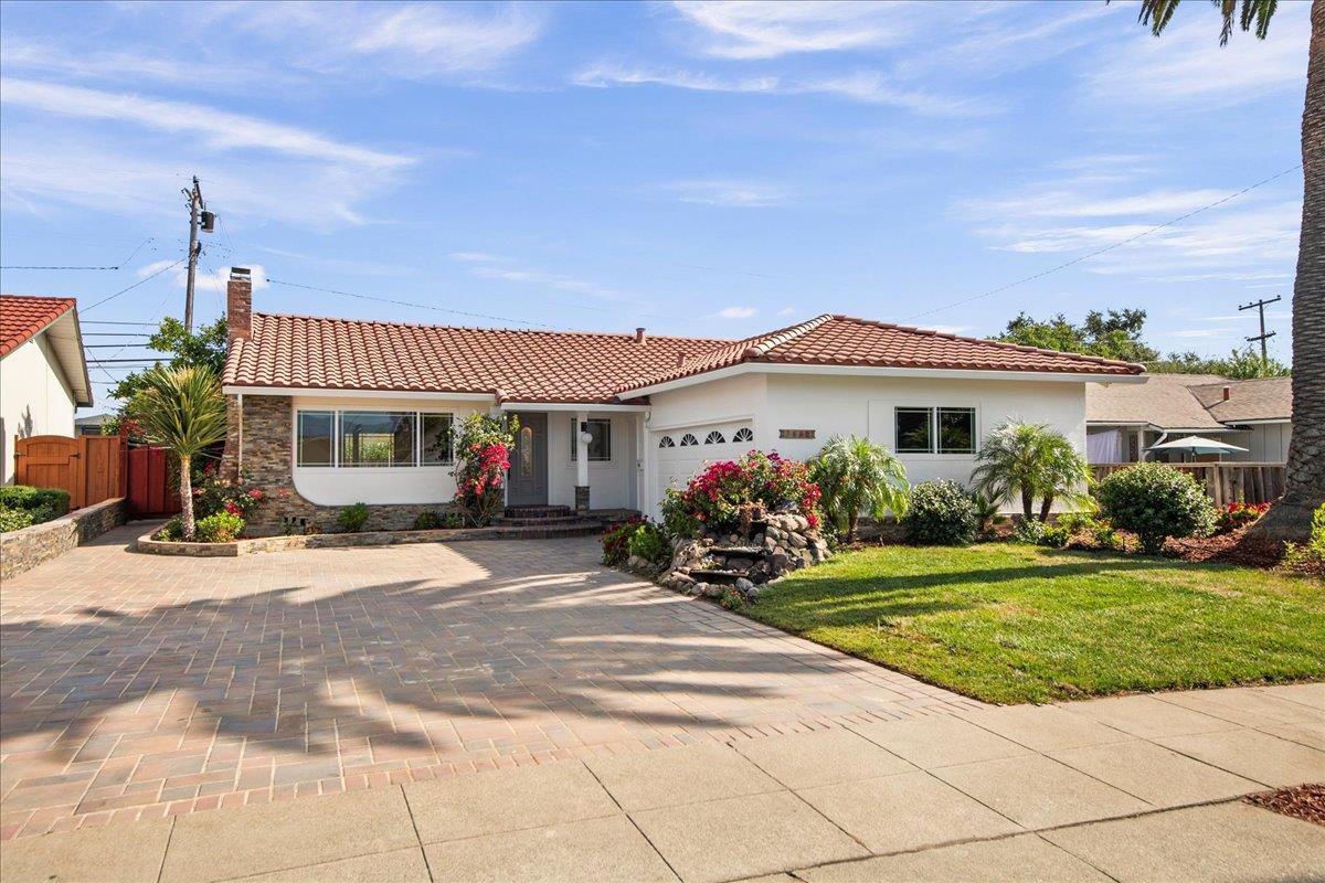 7669 Rainbow Drive Cupertino, CA 95014 - Photo 6 of 37 a front view of a house with a garden and yard